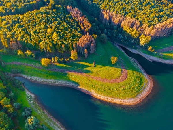 Aerial view of green mountains and river , view from above.