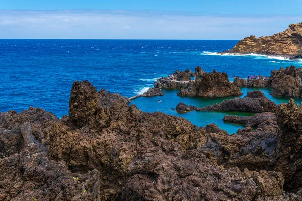 Natural pools with black volcanic rock in the Atlantic Ocean Porto Moniz, Madeira, Portugal