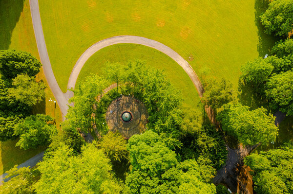 A curvy path through the green meadow, aerial photo