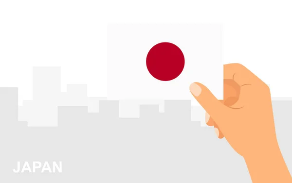 市内を背景に日本の国旗をミニマルなフラットスタイルで手に取ります ベクターイラスト — ストックベクタ