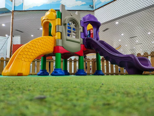 Modern indoor children\'s playground. Colorfull indoor slide kindergarten area. No people.