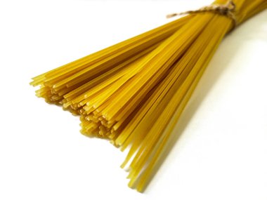 Pişmemiş spagetti beyaz arka planda izole edilmiş. Seçici odak resmi