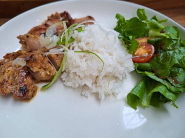 Grilled chicken, salad and white rice, a combination of low calorie menu for diet