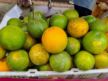 Fresh orange fruits in the basket for sale in the market. Selective focus
