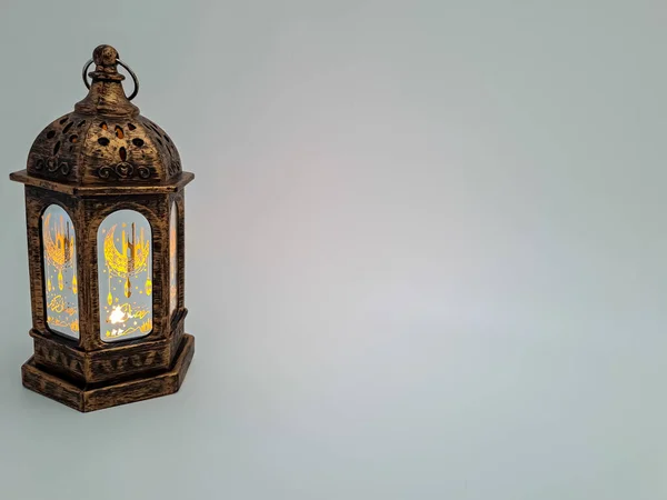 Bronze arabic lantern with yellow light isolated and word in arabic letter \