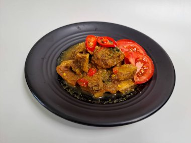 Tengkleng, Endonezya körisi. Biftek ya da kuzu kemikli. Ana malzemeler olarak, Meksika 'ya benziyor. Beyaz arkaplanda izole edilmiş siyah plaka üzerinde servis edilir