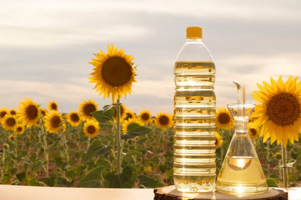 still life with bottle of sunflower oil in the field with organic sunflowers outdoors