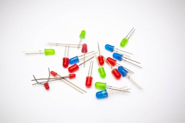 Beyaz zemin üzerinde kırmızı, yeşil ve mavi renkli bir LED (Light Emitting Diode) koleksiyonu. LED elektronik meraklıları için bir DIY malzemesidir..