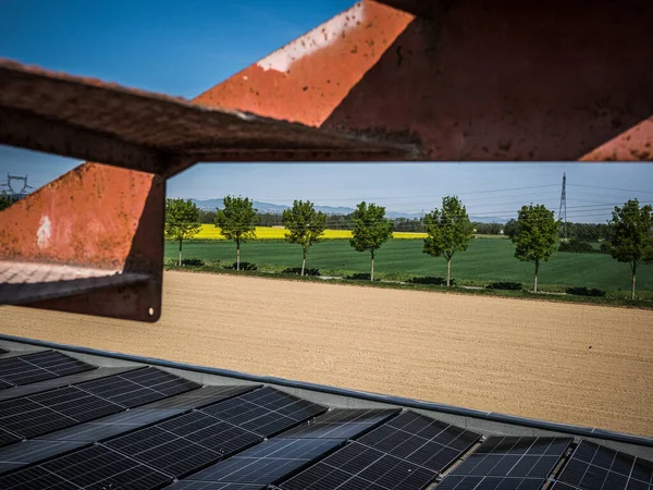 View of a company roof equipped with solar panels in the middle of the countryside