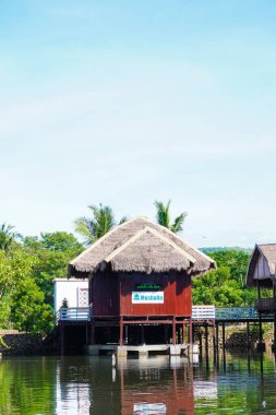 Pare - pare, November 25, 2022: Old traditional white cottage with thatched roof