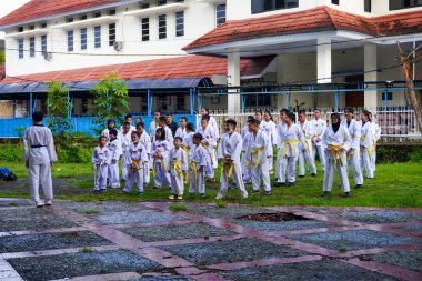 Makassar, October 16, 2022: Children practice taekwondo and traditional martial arts in the park