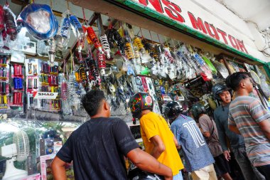 Makassar - Indonesia, July 09, 2022: Motorcycle spare part shop that is full of buyers