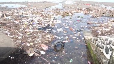 Pare-pare, 24 Kasım 2022, sahil kirliliği. Kıyı şeridinde bir sürü çöp, plastik torba ve çöp var. 4k çözünürlüğü