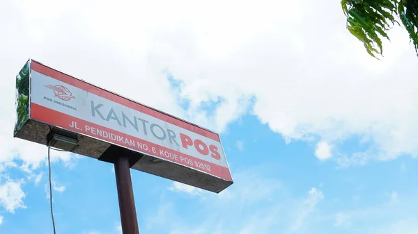 stock image Corporate signage of PT. Pos Indonesia with a clear blue sky in the background on November 11th, 2022 in Bulukumba