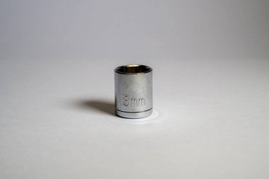 Tek bir, on üç milimetrelik soket anahtarı temiz beyaz bir yüzey üzerinde duruyor, gösteriş araçları ve DIY projeleri için mükemmel..