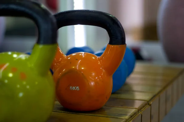 Cast iron weightlifting fitness weights arranged inside a fitness center for healthy lifestyle gym