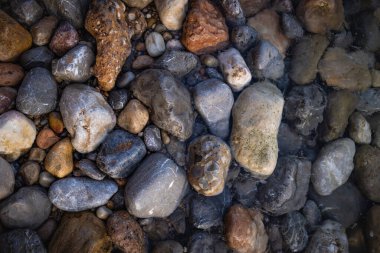 The erosion of water on the rocks, textures and patterns generated on the stones of the beach Ibiza island.