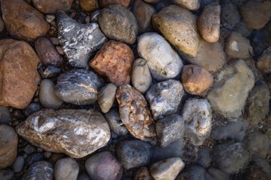 The erosion of water on the rocks, textures and patterns generated on the stones of the beach Ibiza island.