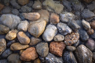 The erosion of water on the rocks, textures and patterns generated on the stones of the beach Ibiza island.