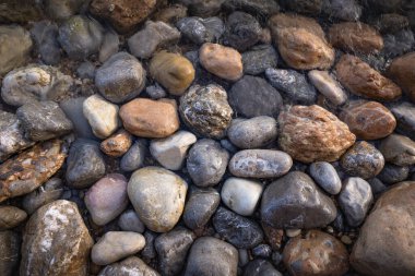 The erosion of water on the rocks, textures and patterns generated on the stones of the beach Ibiza island.