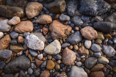 The erosion of water on the rocks, textures and patterns generated on the stones of the beach Ibiza island.