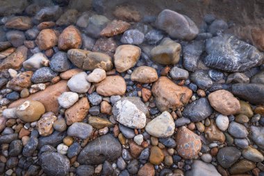 The erosion of water on the rocks, textures and patterns generated on the stones of the beach Ibiza island.