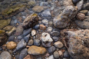 The erosion of water on the rocks, textures and patterns generated on the stones of the beach Ibiza island.