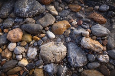 The erosion of water on the rocks, textures and patterns generated on the stones of the beach Ibiza island.