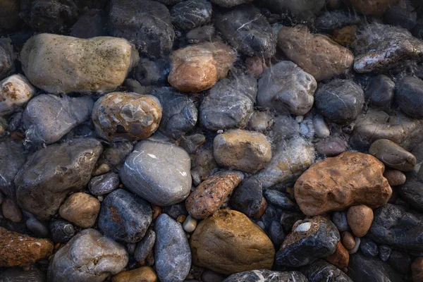 The erosion of water on the rocks, textures and patterns generated on the stones of the beach Ibiza island.