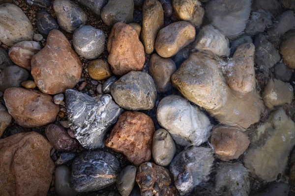 The erosion of water on the rocks, textures and patterns generated on the stones of the beach Ibiza island.