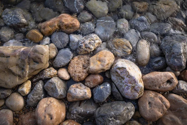 The erosion of water on the rocks, textures and patterns generated on the stones of the beach Ibiza island.