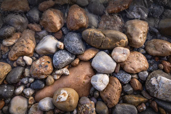The erosion of water on the rocks, textures and patterns generated on the stones of the beach Ibiza island.