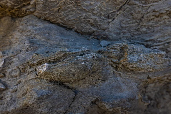 The erosion of water on the rocks, textures and patterns generated on the stones of the beach Ibiza island.