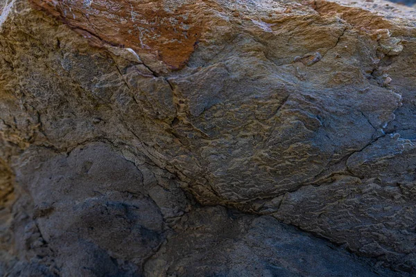 The erosion of water on the rocks, textures and patterns generated on the stones of the beach Ibiza island.