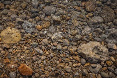 The erosion of water on the rocks, textures and patterns generated on the stones of the beach Ibiza island.