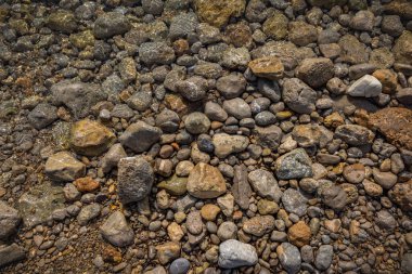 The erosion of water on the rocks, textures and patterns generated on the stones of the beach Ibiza island.
