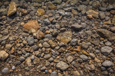 The erosion of water on the rocks, textures and patterns generated on the stones of the beach Ibiza island.