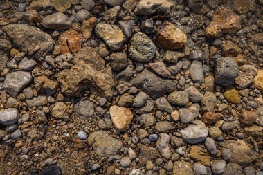 The erosion of water on the rocks, textures and patterns generated on the stones of the beach Ibiza island.