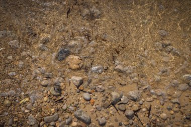 The erosion of water on the rocks, textures and patterns generated on the stones of the beach Ibiza island.