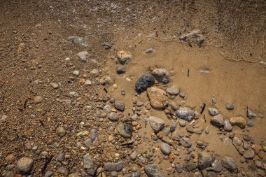 The erosion of water on the rocks, textures and patterns generated on the stones of the beach Ibiza island.