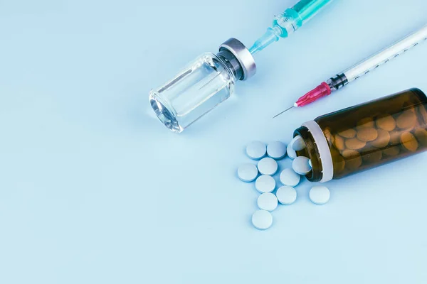 syringe with needle, vial and pills. illegal doping in sport concept , flu vaccine or drug a addicted