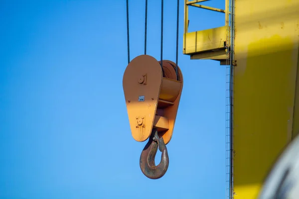 gantry crane with hook against blue sky. an overhead crane on a construction site or in a production hall