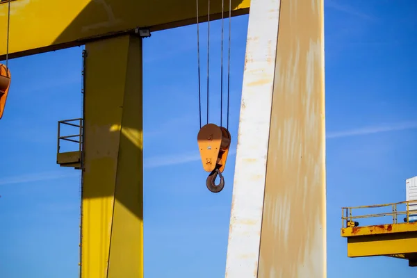 gantry crane with hook against blue sky. an overhead crane on a construction site or in a production hall
