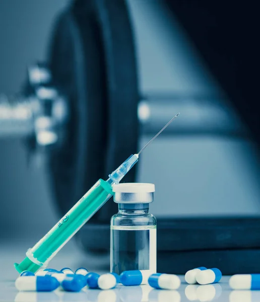 stock image dumbbells, syringe with needle, pills and vial with steroids. illegal doping in sport concept