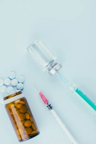 stock image syringe with needle, vial and pills. illegal doping in sport concept, flu vaccine, aesthetic medicine or drugs, narcotics 