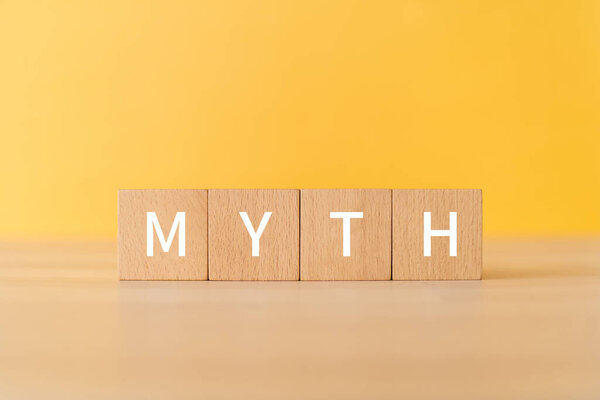 Wooden blocks with "MYTH" text of concept.