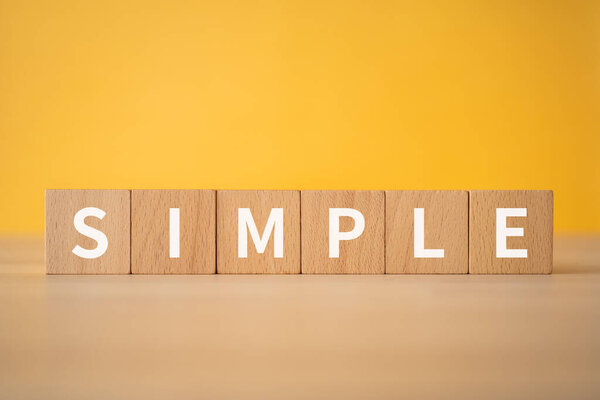 Wooden blocks with "SIMPLE" text of concept.