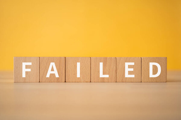 Wooden blocks with "FAILED" text of concept.