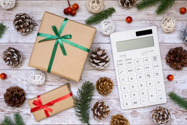 stock image Cost of Christmas gift; Christmas present box, a calculator, and ornament.