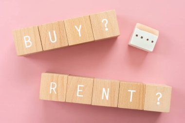 wooden blocks with buy? rent? text of concept.